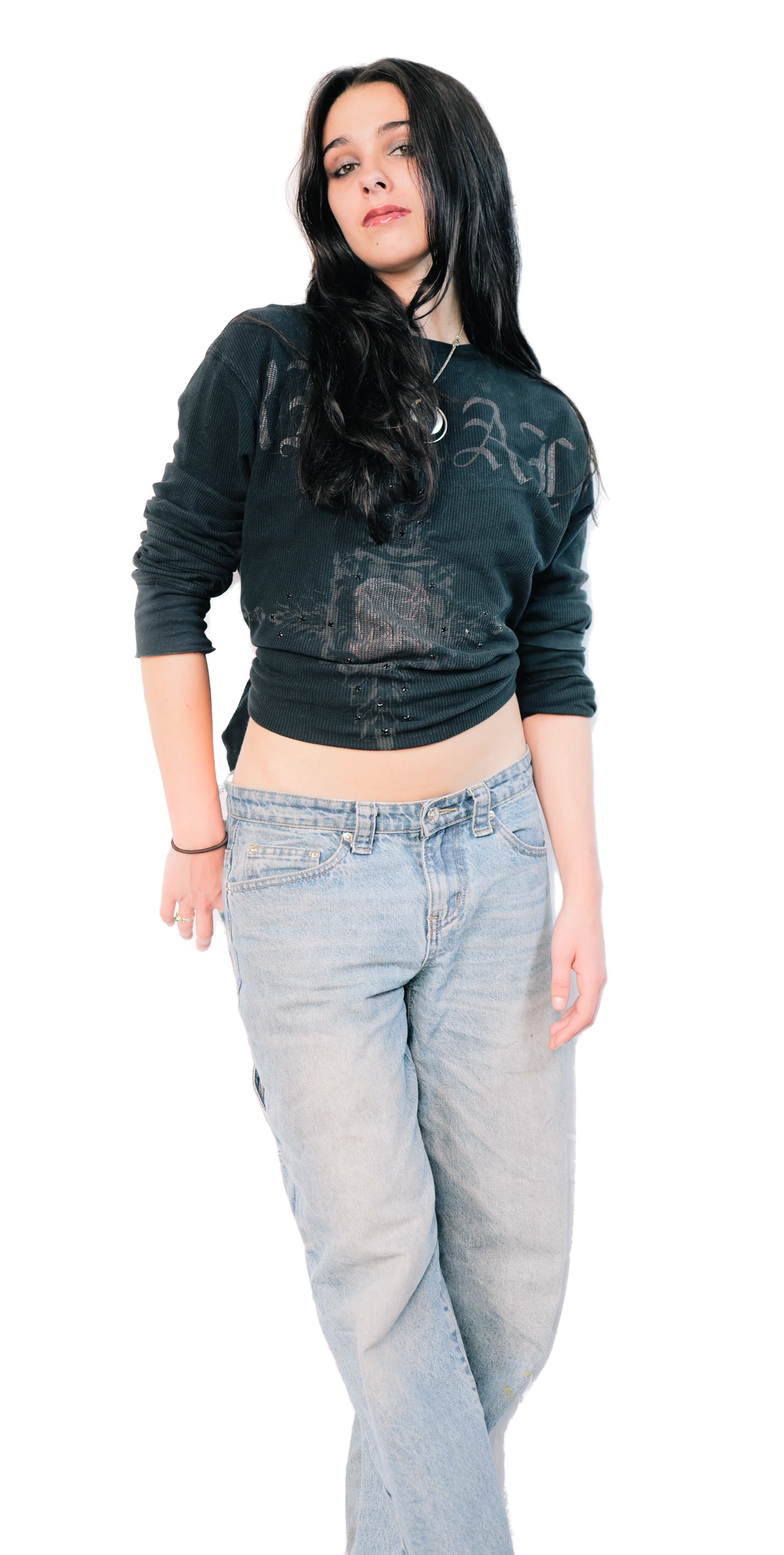 Elisabeth Fitzgerald, three-quarter length in a black long-sleeve top and light jeans, chin raised, looking at the camera